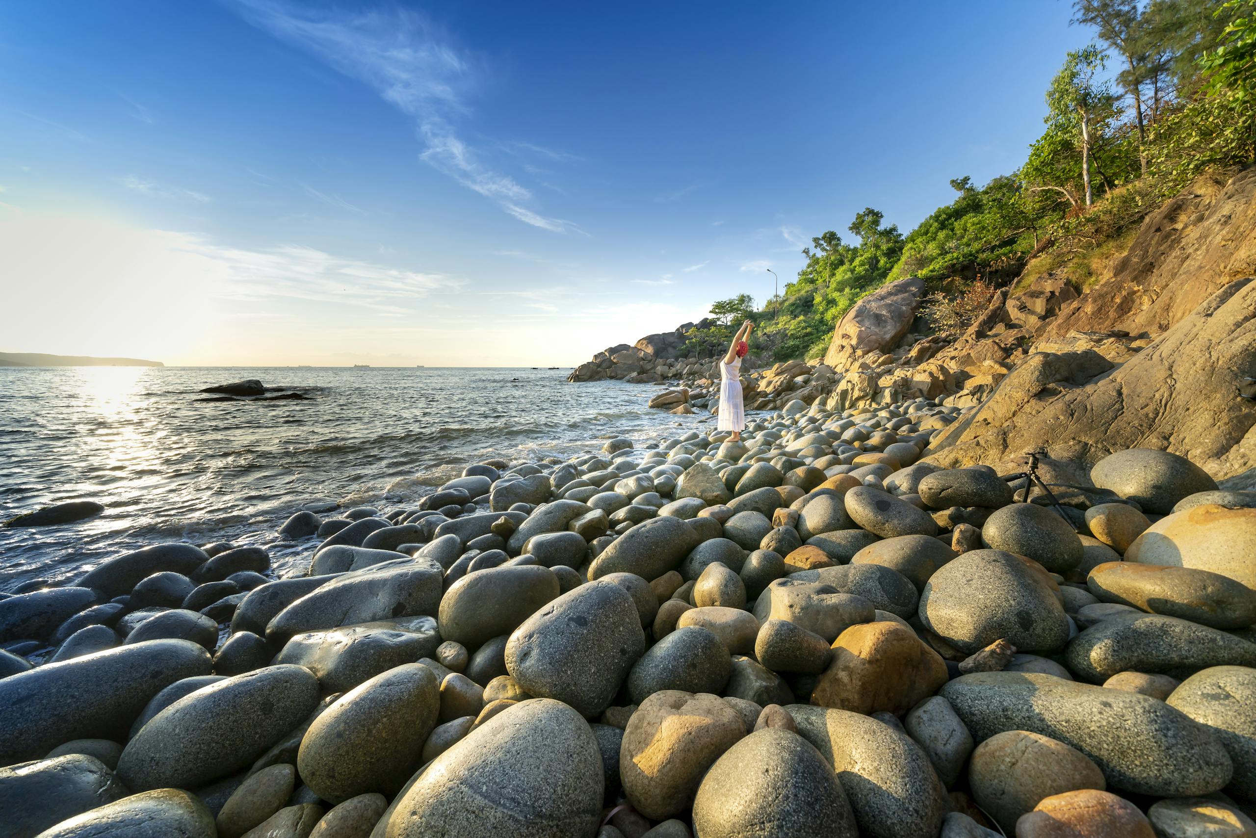 Photo Of Person Standing On Rocky Shore